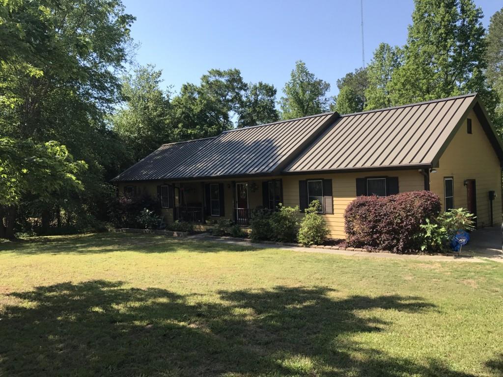 a front view of a house with swimming pool having outdoor seating