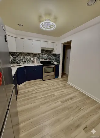 a kitchen with a stove and a refrigerator