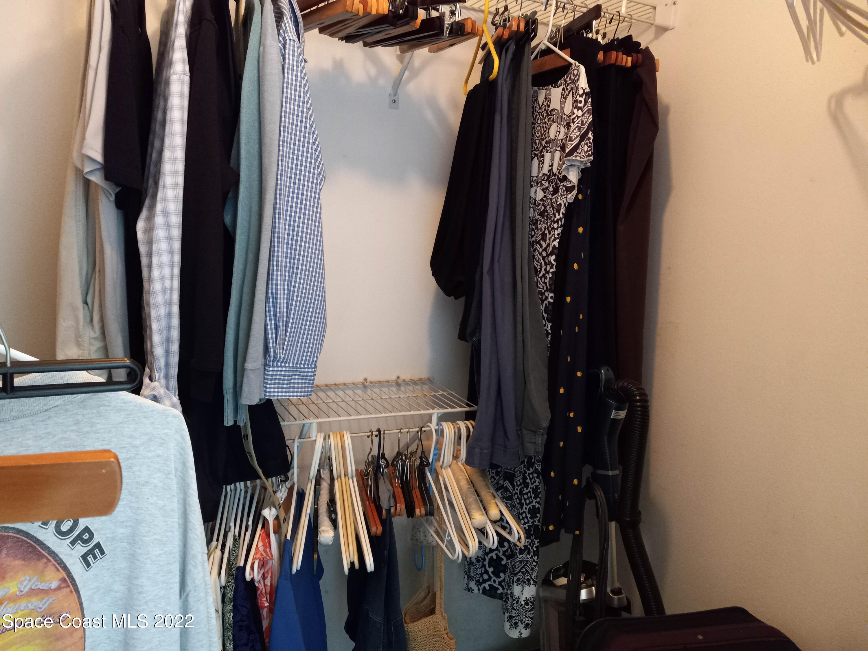5166 Arlington Road Cocoa, FL 32927 - Photo 12 of 25 a view of walk in closet with clothes
