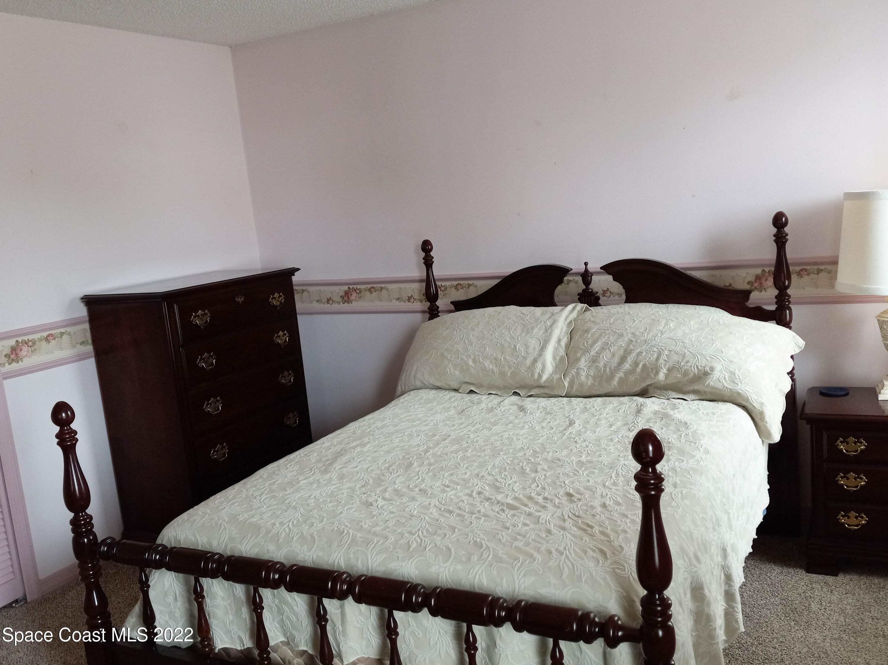 5166 Arlington Road Cocoa, FL 32927 - Photo 14 of 25 a bed sitting in a bedroom with furniture