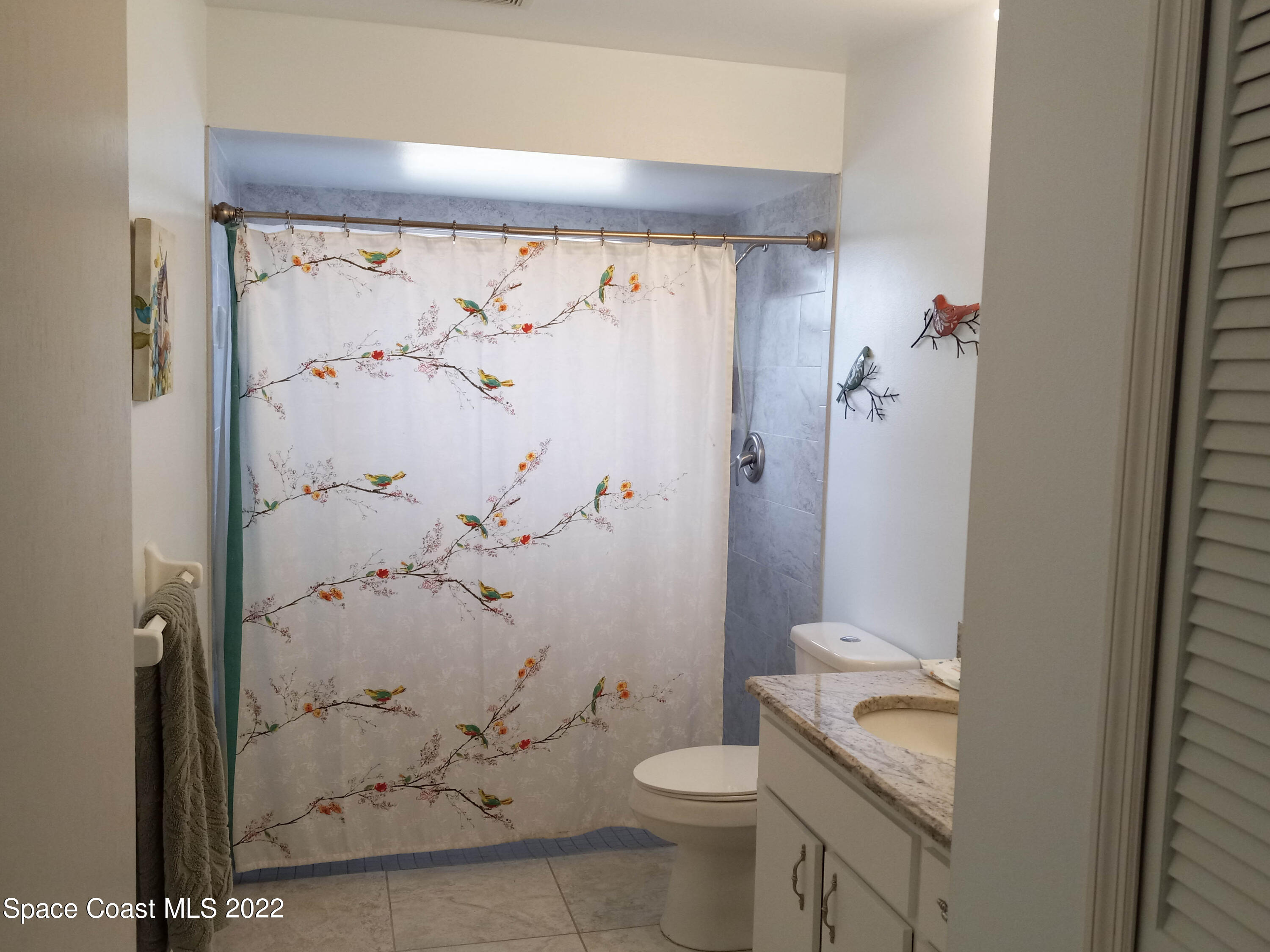 5166 Arlington Road Cocoa, FL 32927 - Photo 16 of 25 a bathroom with a shower and toilet