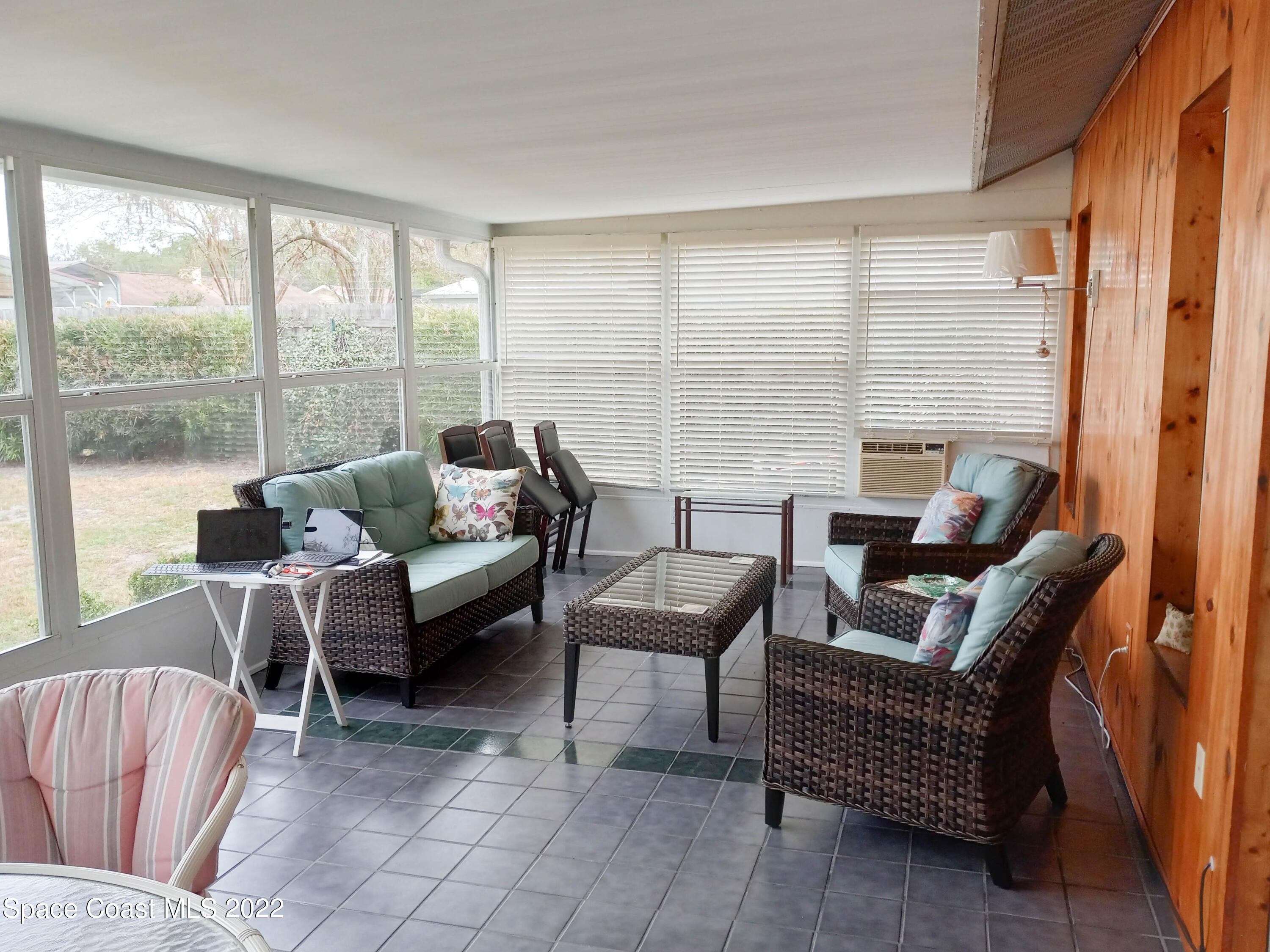 5166 Arlington Road Cocoa, FL 32927 - Photo 19 of 25 a living room with furniture and a floor to ceiling window