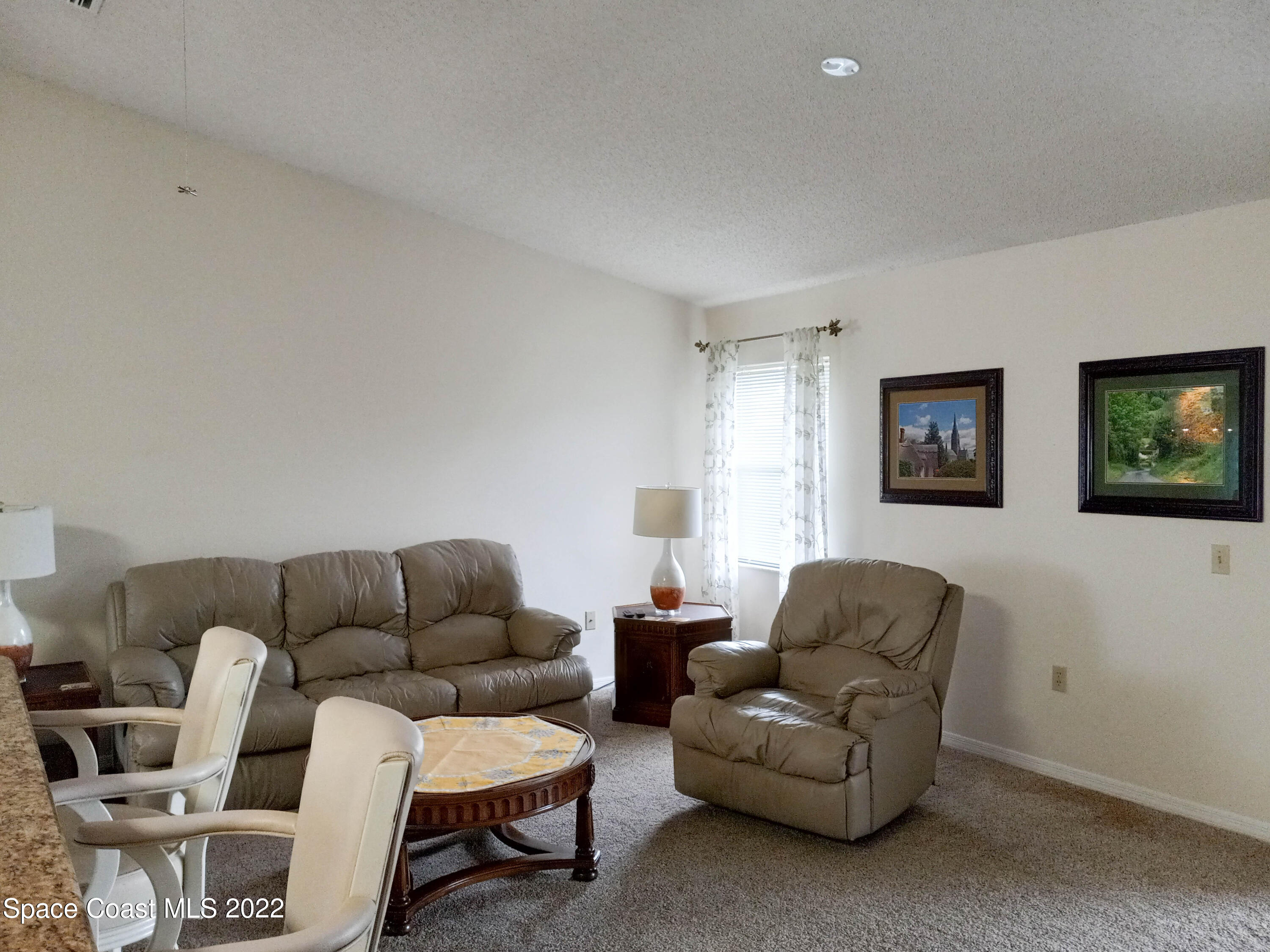 5166 Arlington Road Cocoa, FL 32927 - Photo 2 of 25 a living room with furniture a couch and a window
