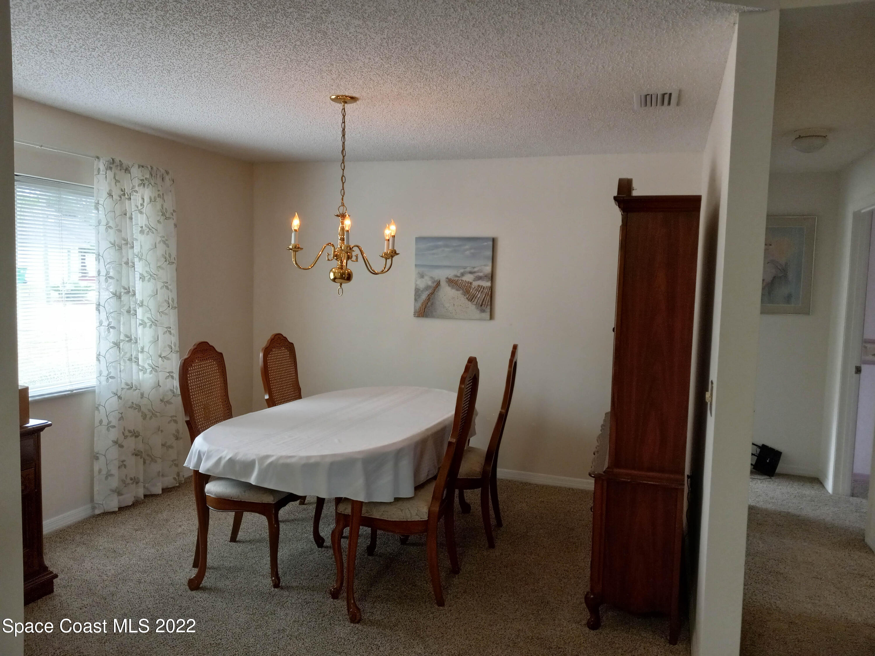 5166 Arlington Road Cocoa, FL 32927 - Photo 4 of 25 a view of a dining room with furniture and chandelier