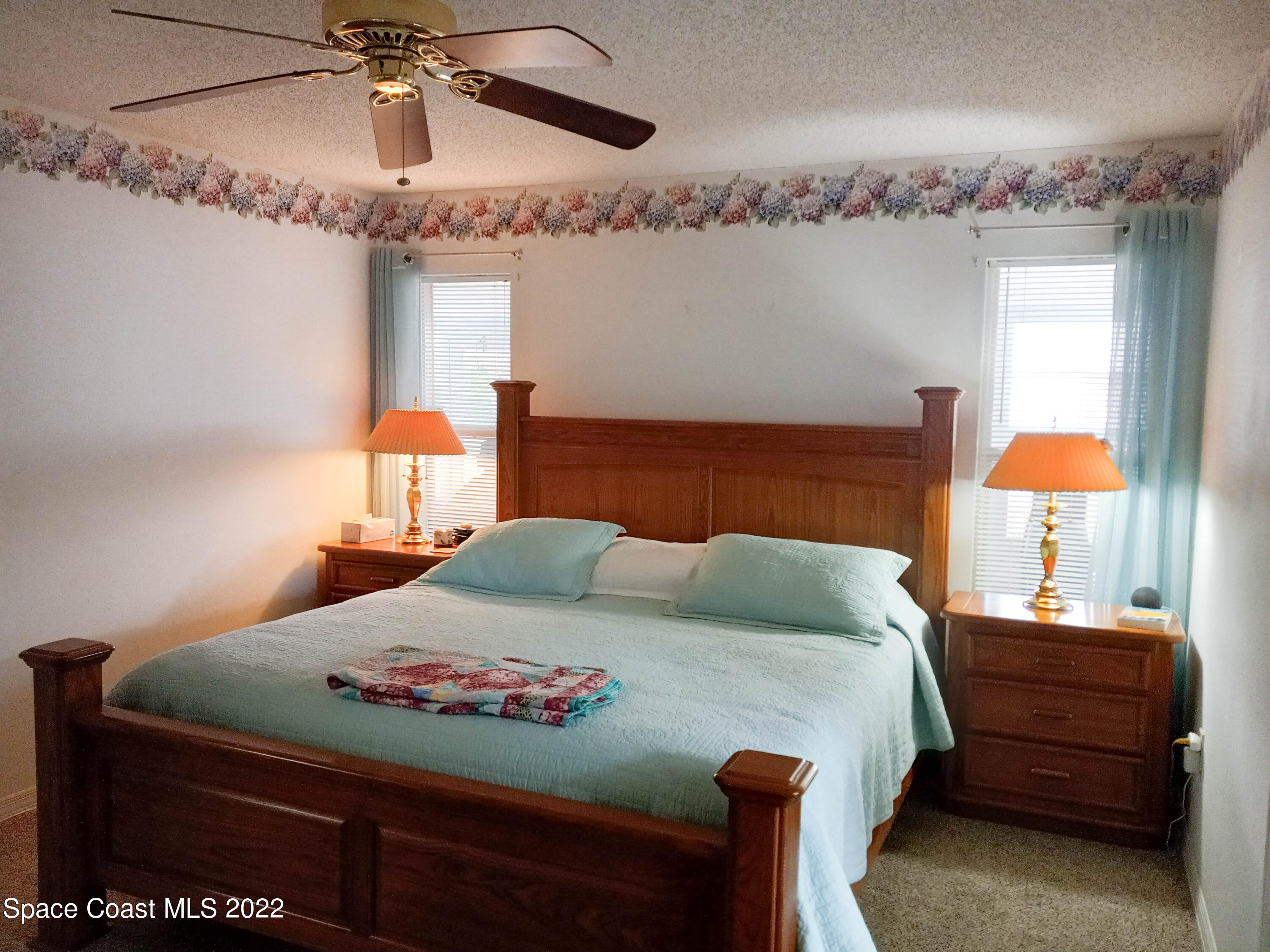 5166 Arlington Road Cocoa, FL 32927 - Photo 9 of 25 a bedroom with a bed and chandelier