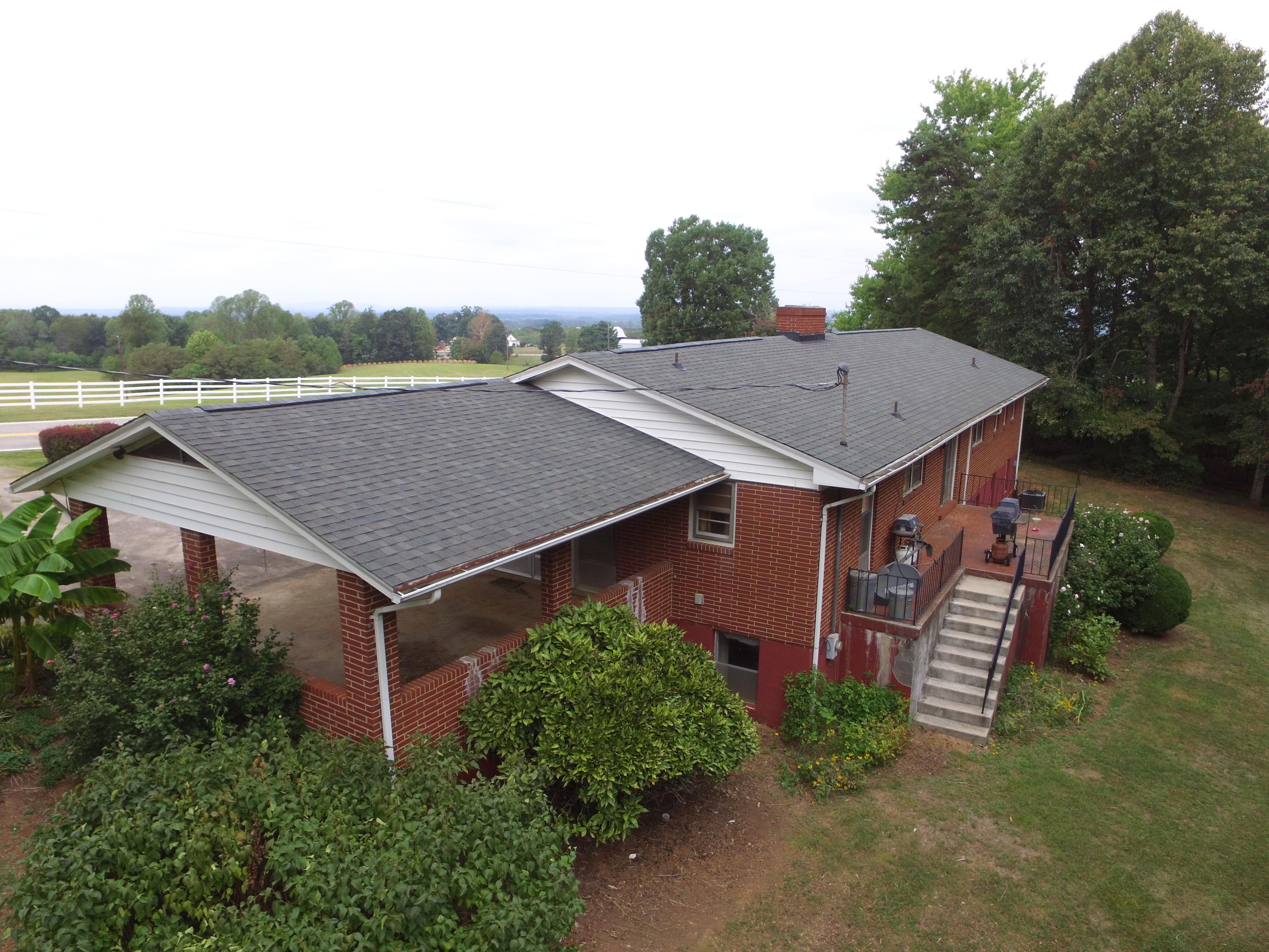 3256 Sago Road Callands, VA 24530 - Photo 54 of 59 an aerial view of a house with yard and trees in the background