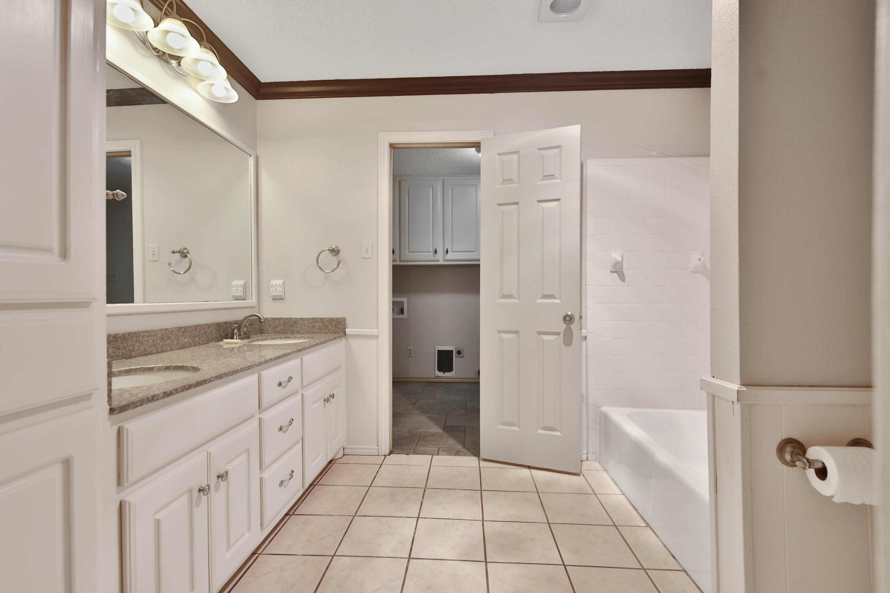 5721 80th Street Lubbock, TX 79424 - Photo 21 of 41 Primary Bathroom to Laundry Room