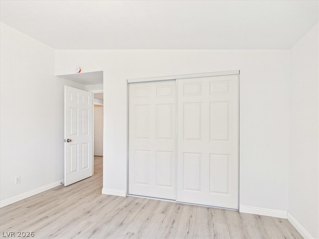 4081 Retread Road Pahrump, NV 89048 - Photo 49 of 98 A well-lit bedroom features durable laminate flooring and practical sliding closet doors.