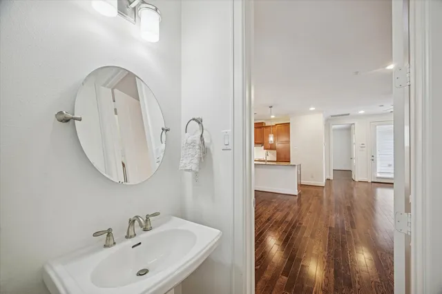 an empty room with chandelier fan and windows