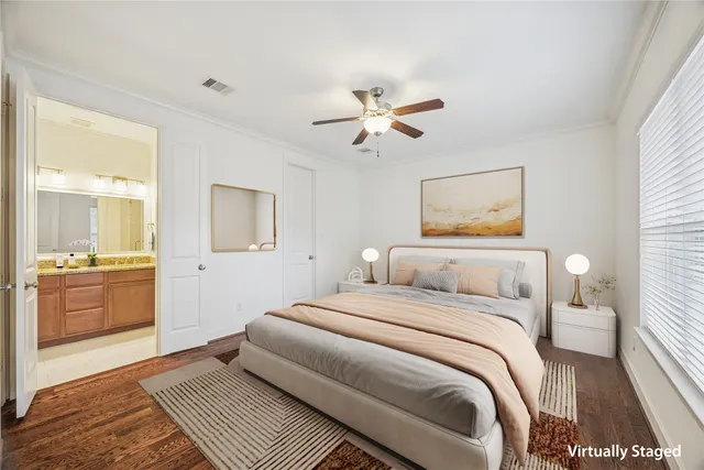 an empty room with window and ceiling fan