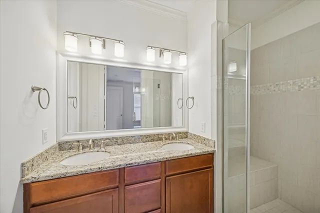 a bathroom with a granite countertop sink toilet and shower