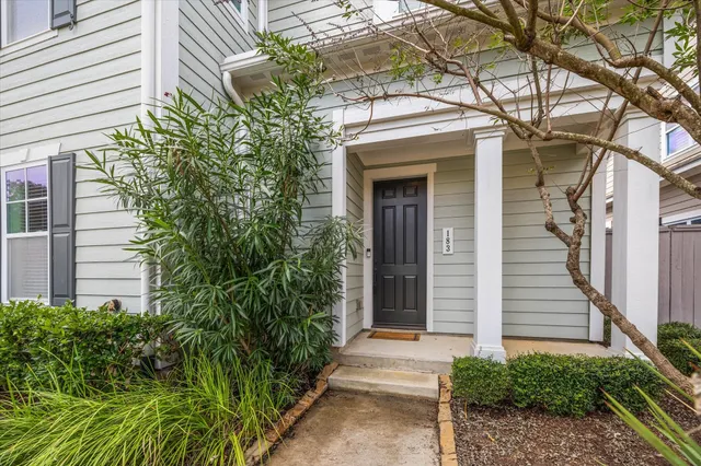 a kitchen with stainless steel appliances granite countertop a stove a sink and a wooden floors