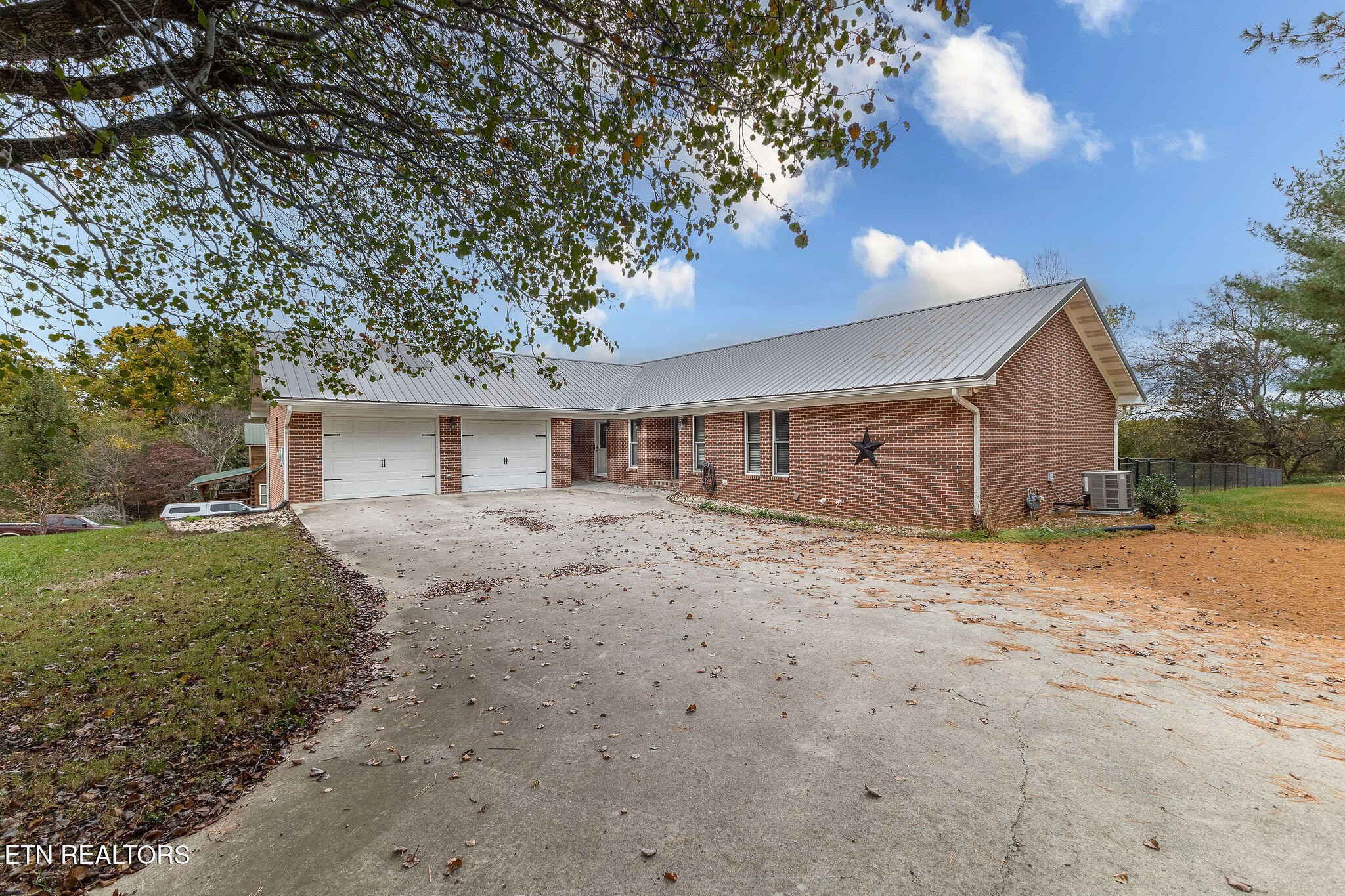 6251 Grimes Road Loudon, TN 37774 - Photo 1 of 43 a front view of a house with a yard and garage