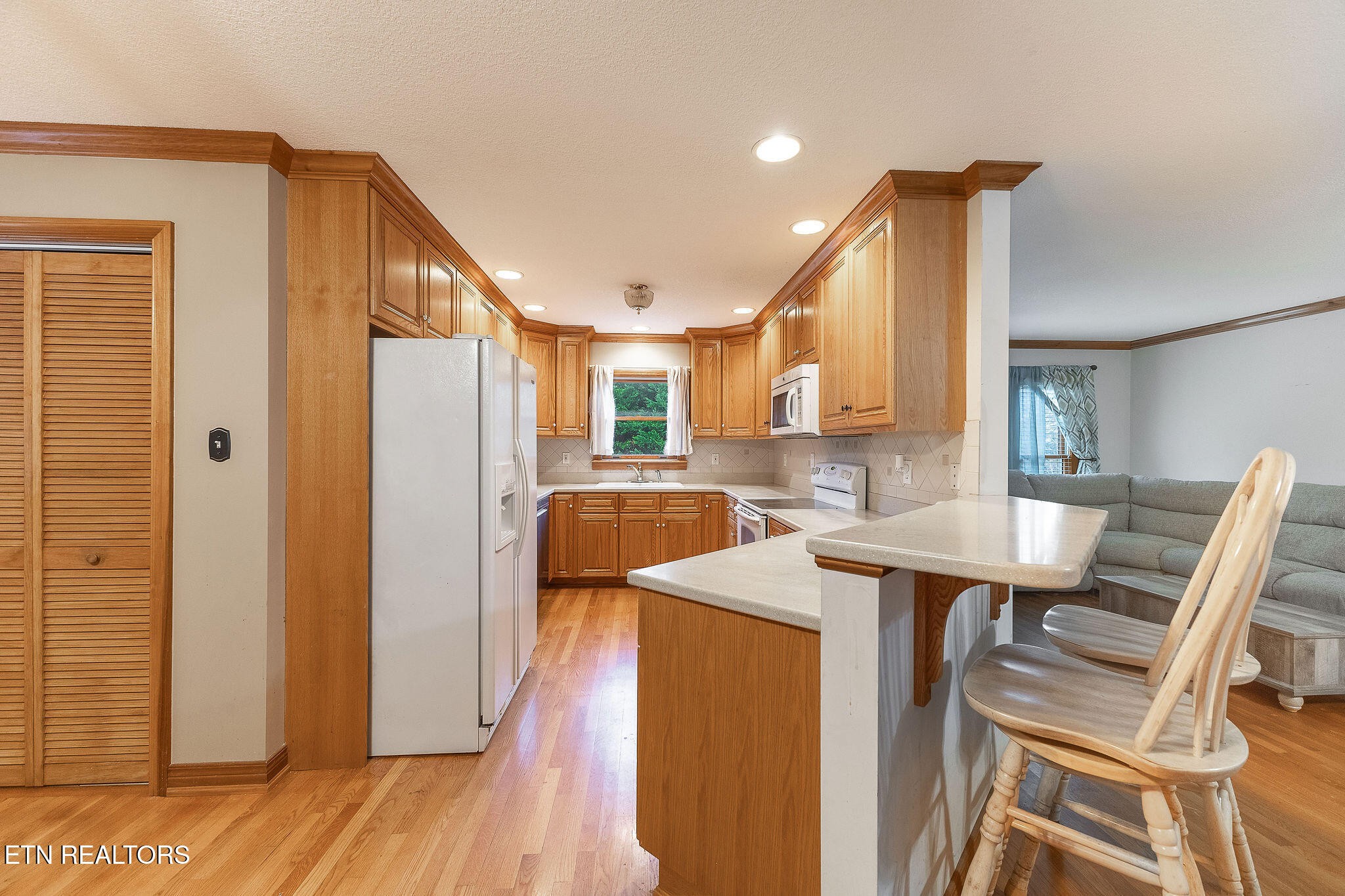 6251 Grimes Road Loudon, TN 37774 - Photo 8 of 43 a kitchen with stainless steel appliances kitchen island granite countertop a refrigerator a stove and a wooden cabinets