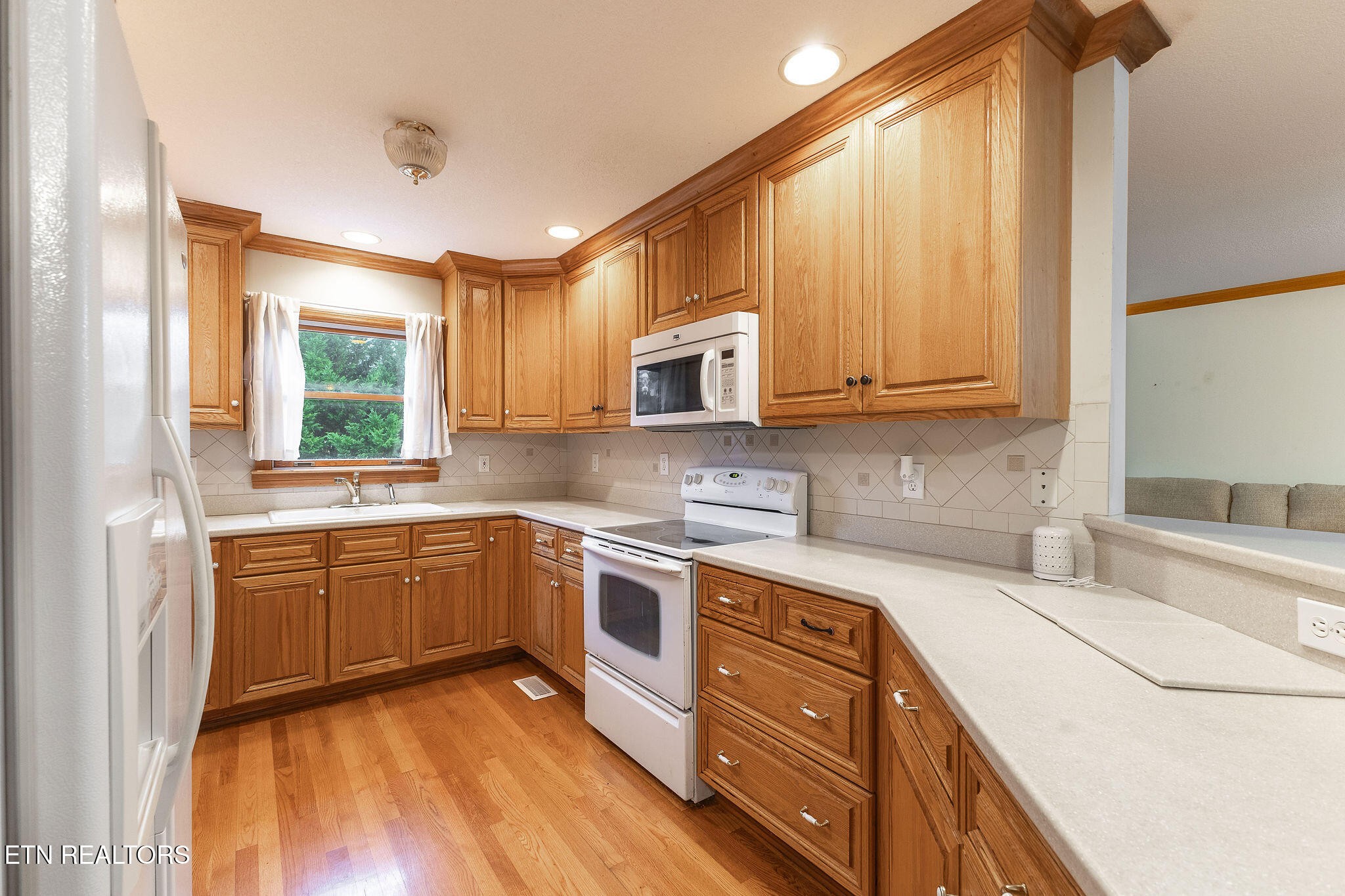 6251 Grimes Road Loudon, TN 37774 - Photo 9 of 43 a kitchen with stainless steel appliances granite countertop wooden cabinets a sink and dishwasher a stove with wooden floor