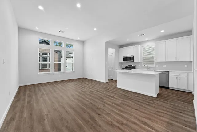 a view of kitchen with granite countertop cabinets and wooden floor