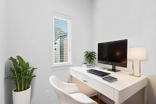 a work room with furniture and a potted plant