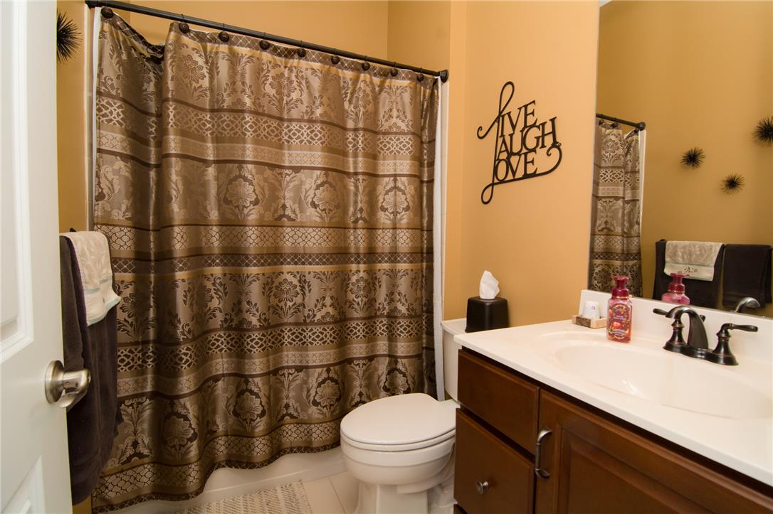 4097 Rutz Lane Allentown, PA 18104 - Photo 35 of 59 Warm wall tones pair with a dark wood vanity and traditional fixtures.