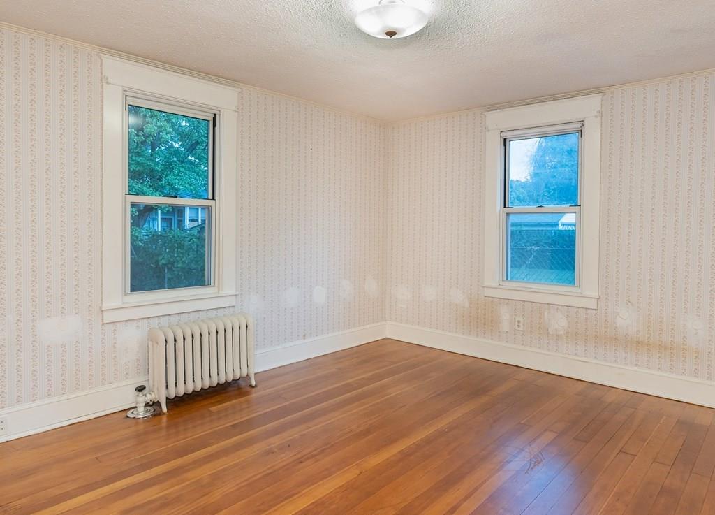 90 Merida Street Springfield, MA 01104 - Photo 16 of 26 a view of an empty room with wooden floor and a window
