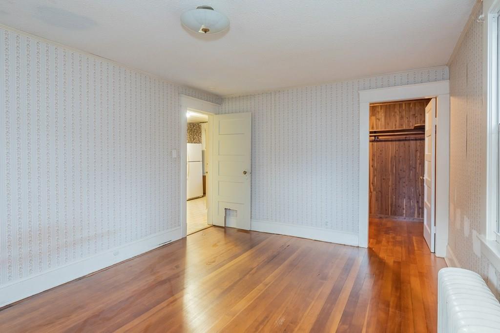 90 Merida Street Springfield, MA 01104 - Photo 18 of 26 wooden floor in an empty room with a window
