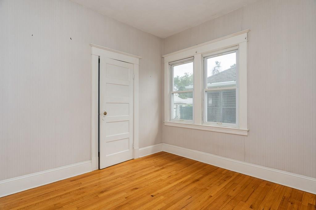 90 Merida Street Springfield, MA 01104 - Photo 21 of 26 an empty room with wooden floor and windows