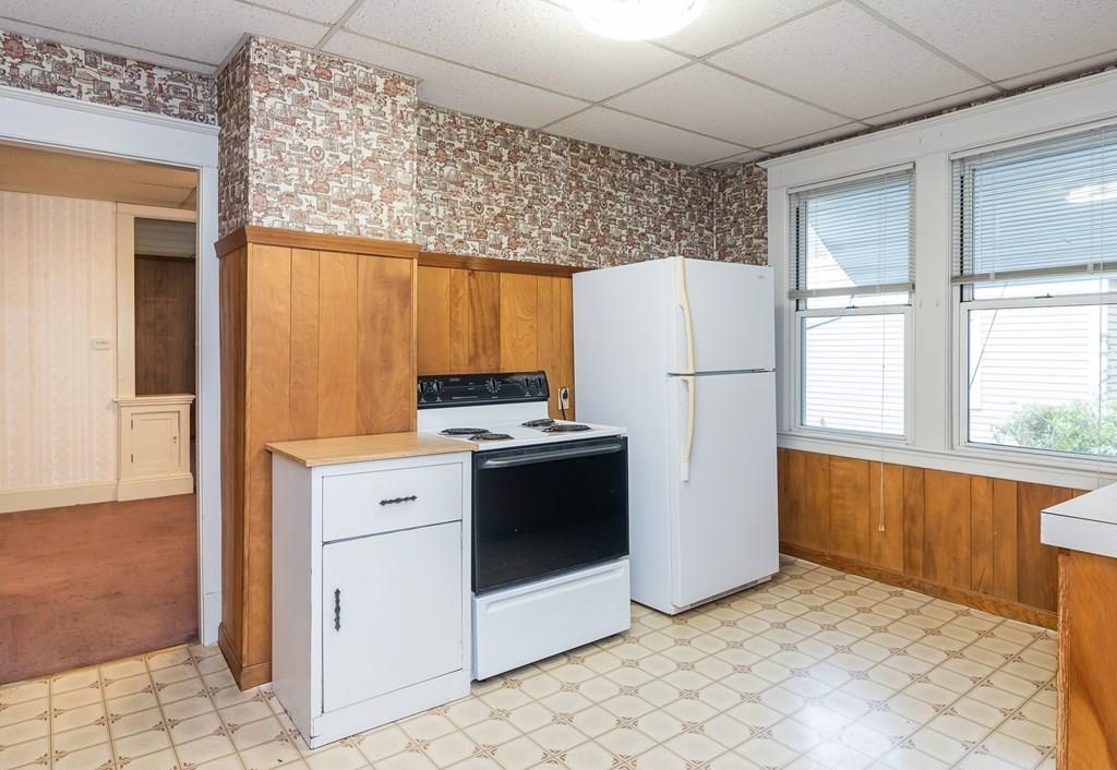 90 Merida Street Springfield, MA 01104 - Photo 4 of 26 a kitchen with a refrigerator sink stove and cabinets