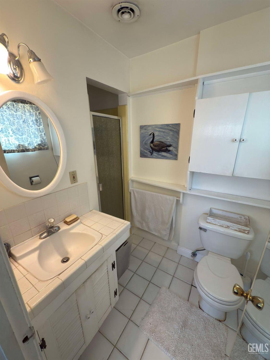 Undisclosed Address Bakersfield, CA 93306 - Photo 11 of 17 a bathroom with a sink toilet and mirror
