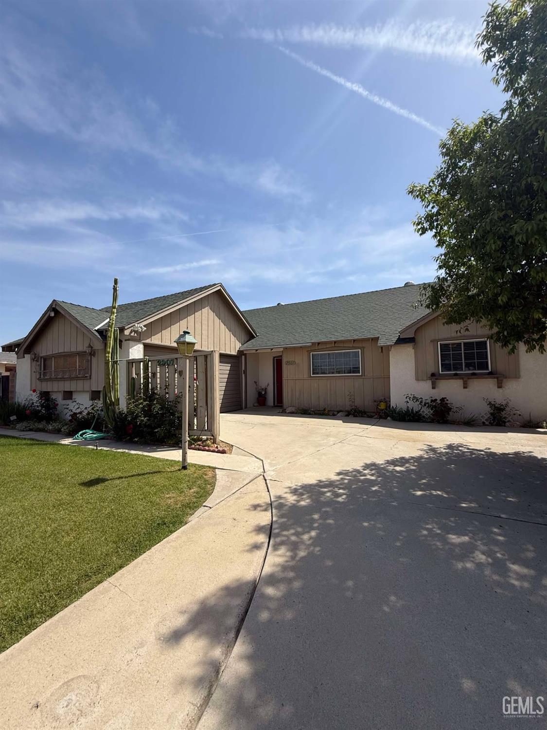 Undisclosed Address Bakersfield, CA 93306 - Photo 2 of 17 a front view of a house with a yard and garage