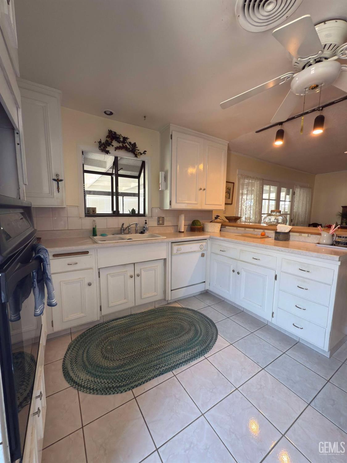 Undisclosed Address Bakersfield, CA 93306 - Photo 4 of 17 a kitchen with a sink a stove and cabinets