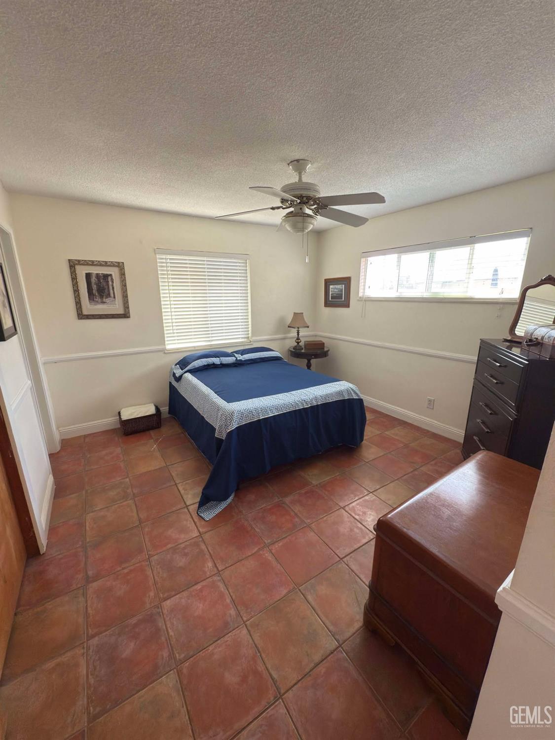 Undisclosed Address Bakersfield, CA 93306 - Photo 9 of 17 a spacious bedroom with a bed and a chandelier