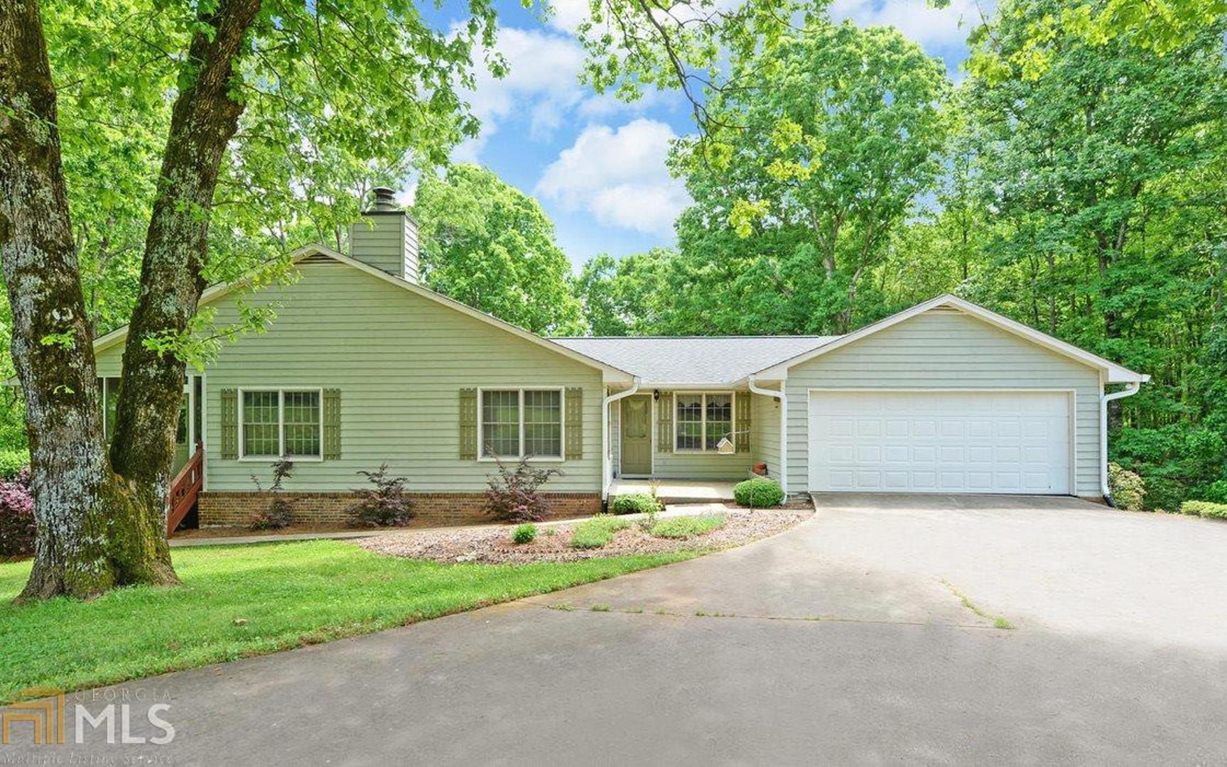 596 Paradise Park Road Cornelia, GA 30531 - Photo 1 of 1 a front view of house with yard and green space