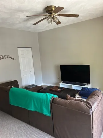 a bedroom with a bed and a television