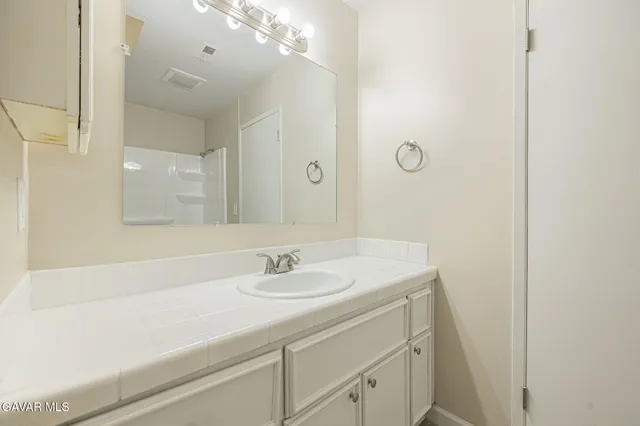 a bathroom with a sink a vanity and a mirror
