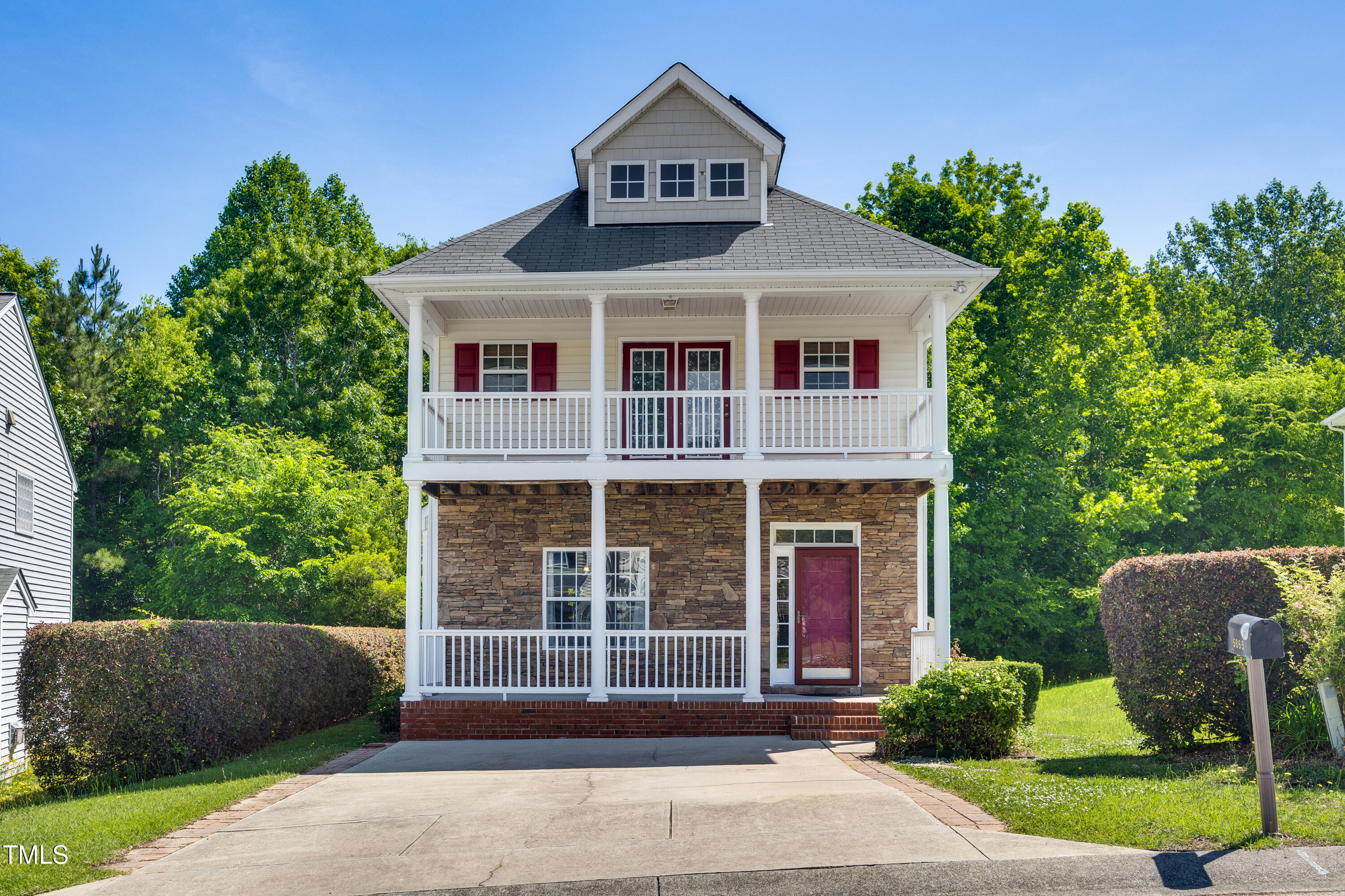 a front view of a house with a garden
