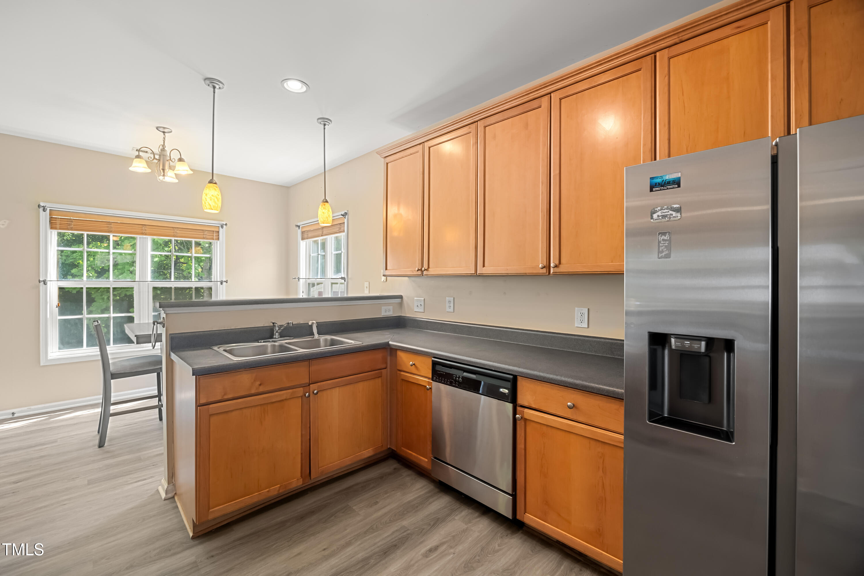 5865 Forest Point Road Raleigh, NC 27610 - Photo 12 of 37 a kitchen with stainless steel appliances granite countertop a sink a stove and a refrigerator