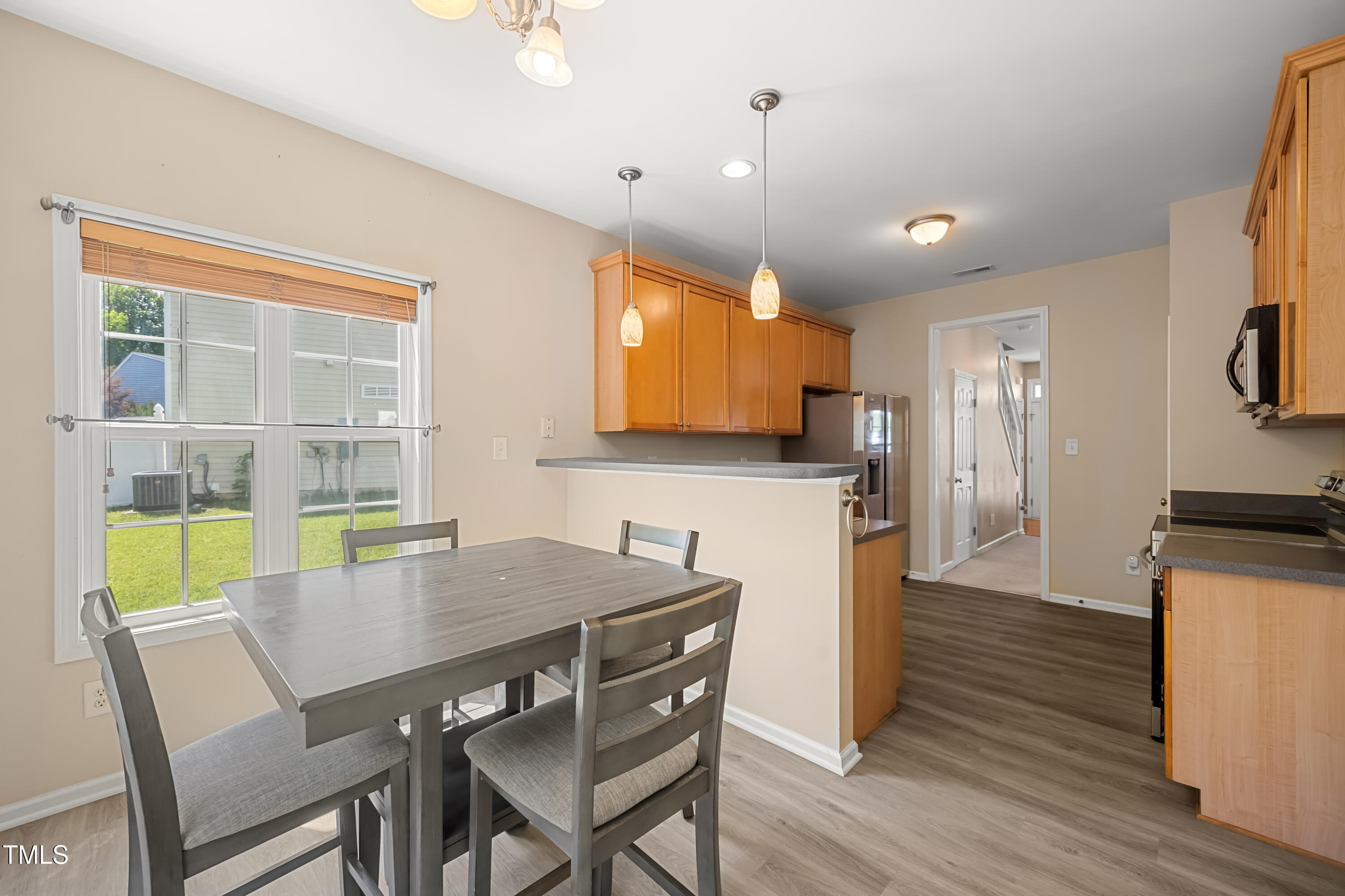 5865 Forest Point Road Raleigh, NC 27610 - Photo 14 of 37 a view of a dining room with furniture and a window
