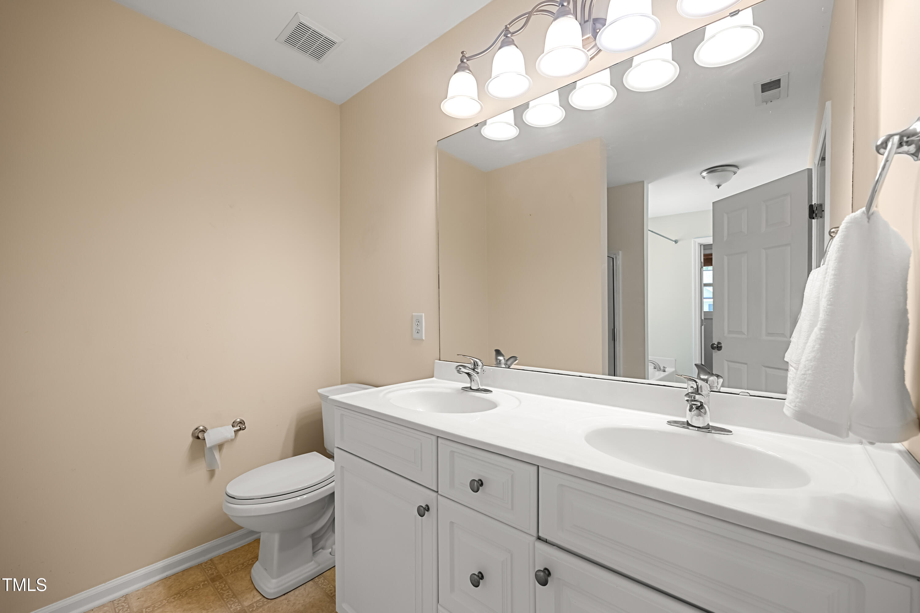 5865 Forest Point Road Raleigh, NC 27610 - Photo 22 of 37 a bathroom with a sink a toilet and a mirror