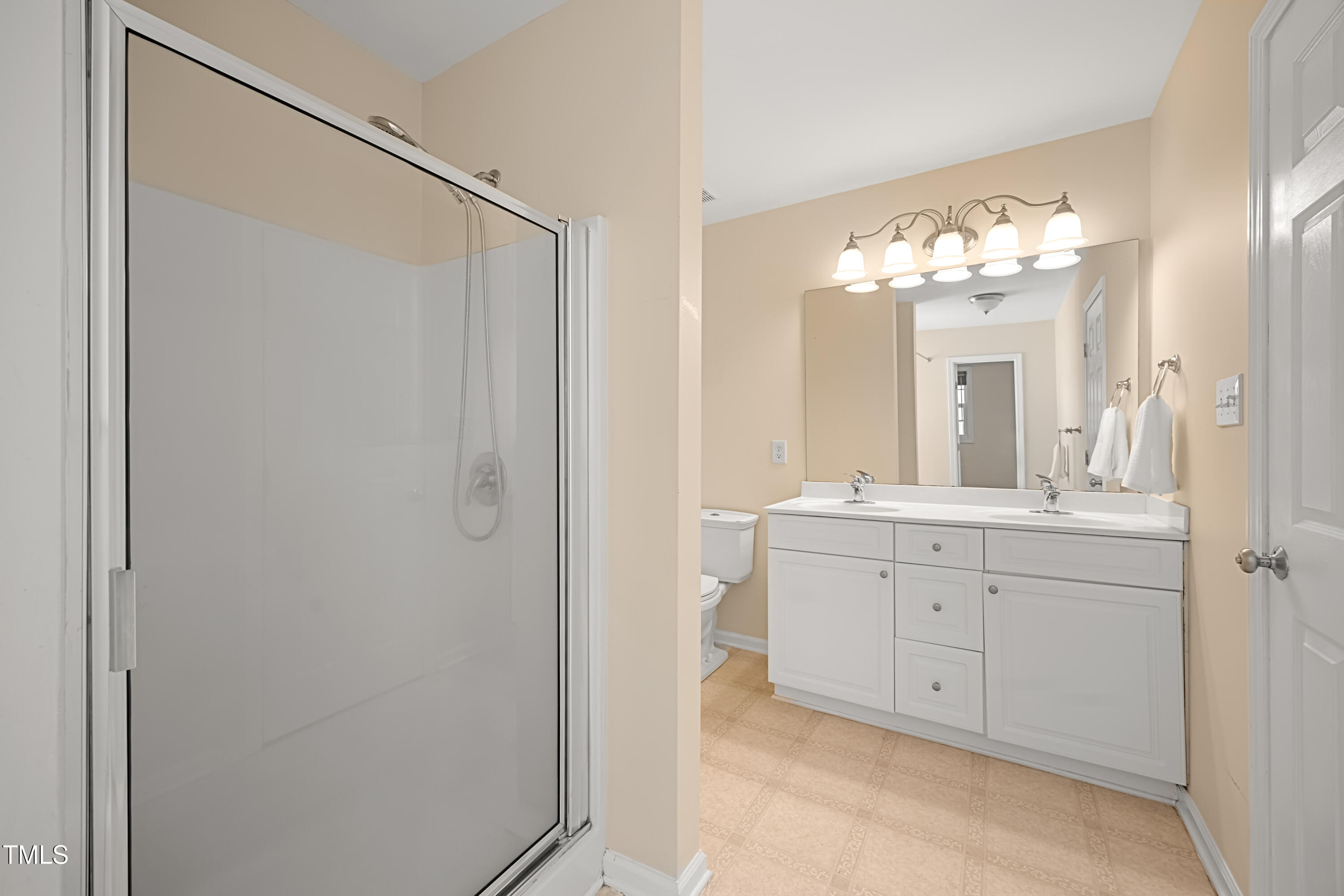 5865 Forest Point Road Raleigh, NC 27610 - Photo 23 of 37 a spacious bathroom with a double vanity sink mirror and shower