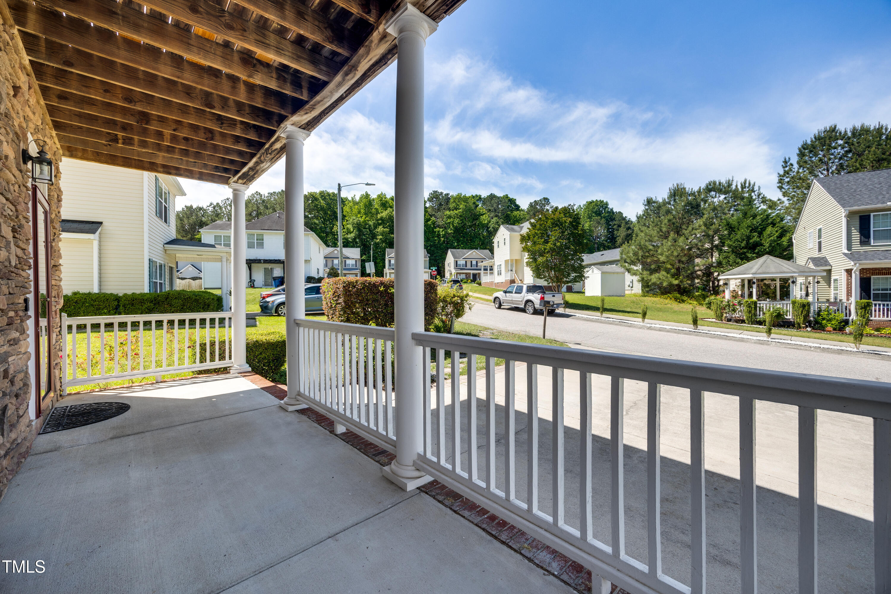 5865 Forest Point Road Raleigh, NC 27610 - Photo 3 of 37 a view of a porch with wooden floor and iron fence