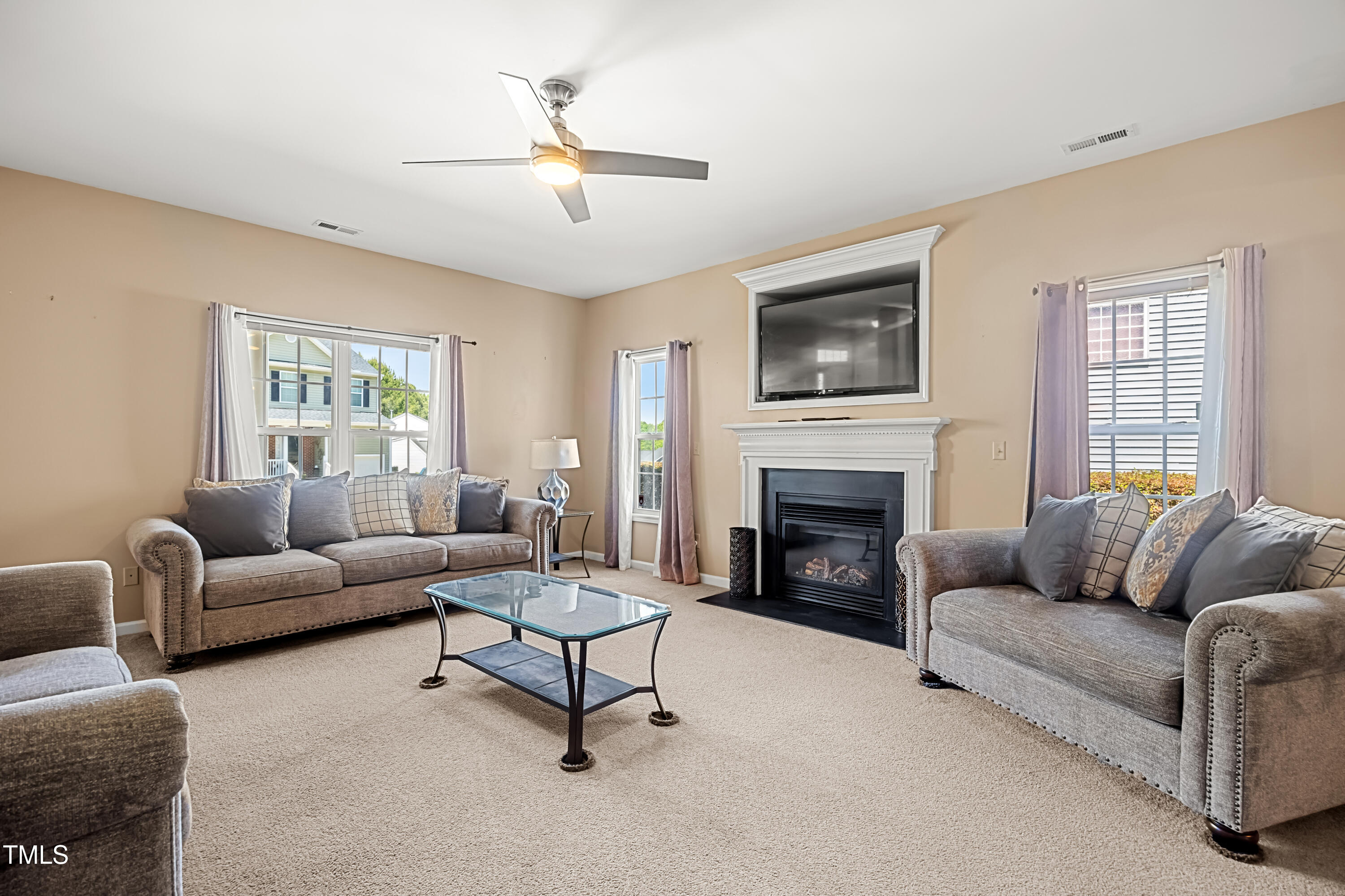 5865 Forest Point Road Raleigh, NC 27610 - Photo 8 of 37 a living room with furniture and a fireplace