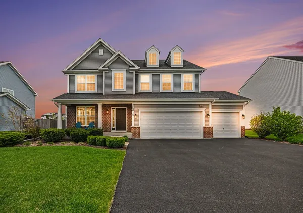 a front view of a house with a yard and garage