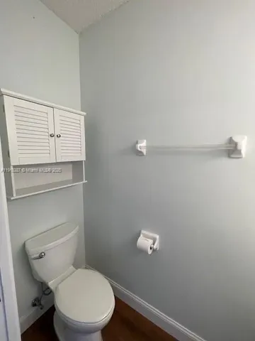 a white toilet sitting next to a shower