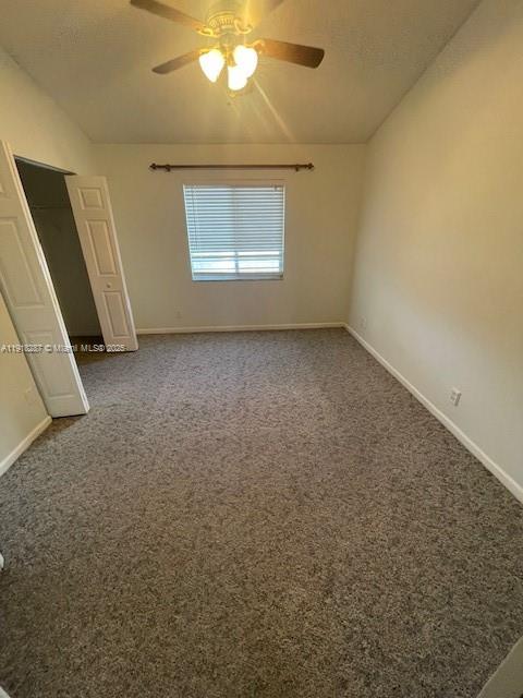 4938 Palmbrooke Circle West Palm Beach, FL 33417 - Photo 21 of 32 an empty room with a chandelier fan and windows