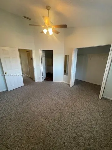 a view of a room with a ceiling fan