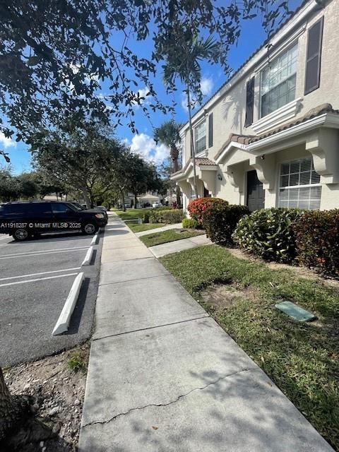 4938 Palmbrooke Circle West Palm Beach, FL 33417 - Photo 31 of 32 a view of a patio with table and chairs and potted plants