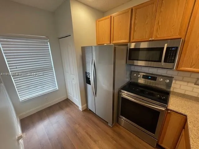 a kitchen with a refrigerator stove and microwave