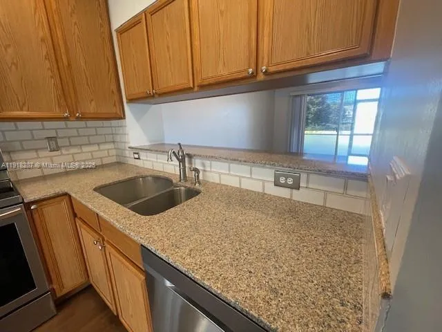 a kitchen with sink cabinets and window