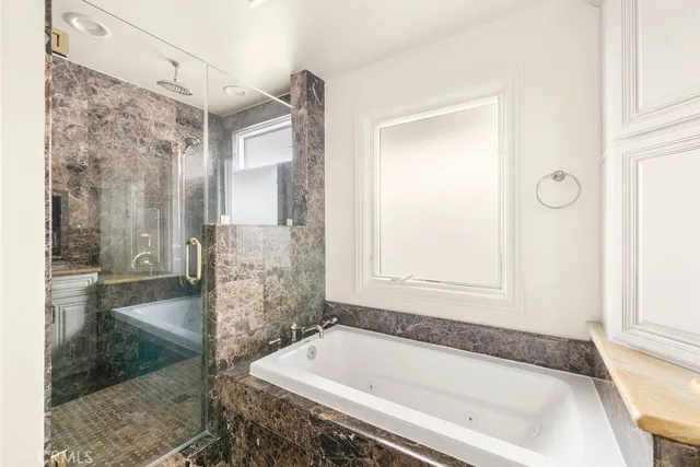a bathroom with a bathtub and a shower