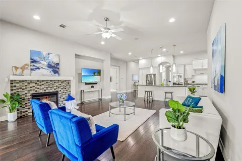 a living room with fireplace furniture and a large window