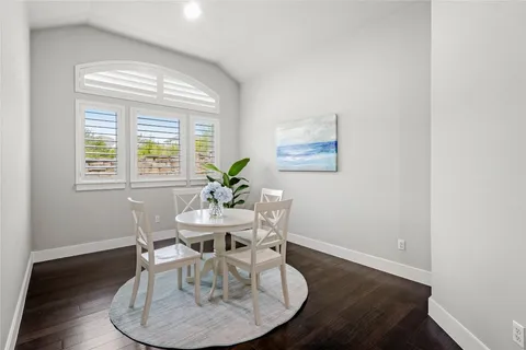 a kitchen with granite countertop white cabinets and stainless steel appliances